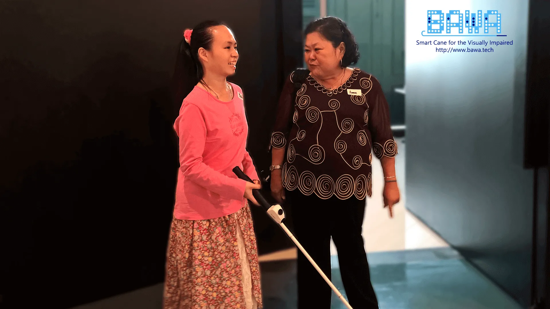 Felicia (born blind), accompanied by Annie Soon (Orientation and Mobility Specialist), experiencing the BAWA Cane.